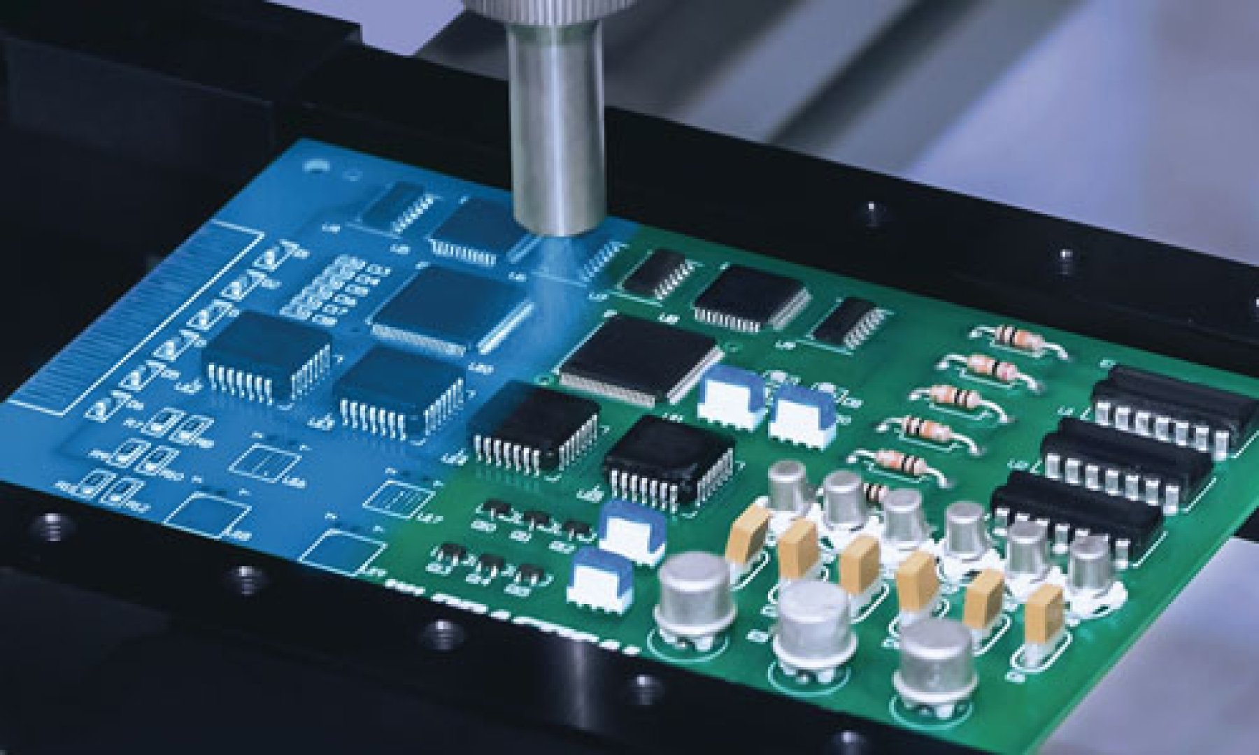 A Dymax conformal coating is dispense sprayed onto a printed circuit board with a SpeedMask maskant applied to protect components during processing.